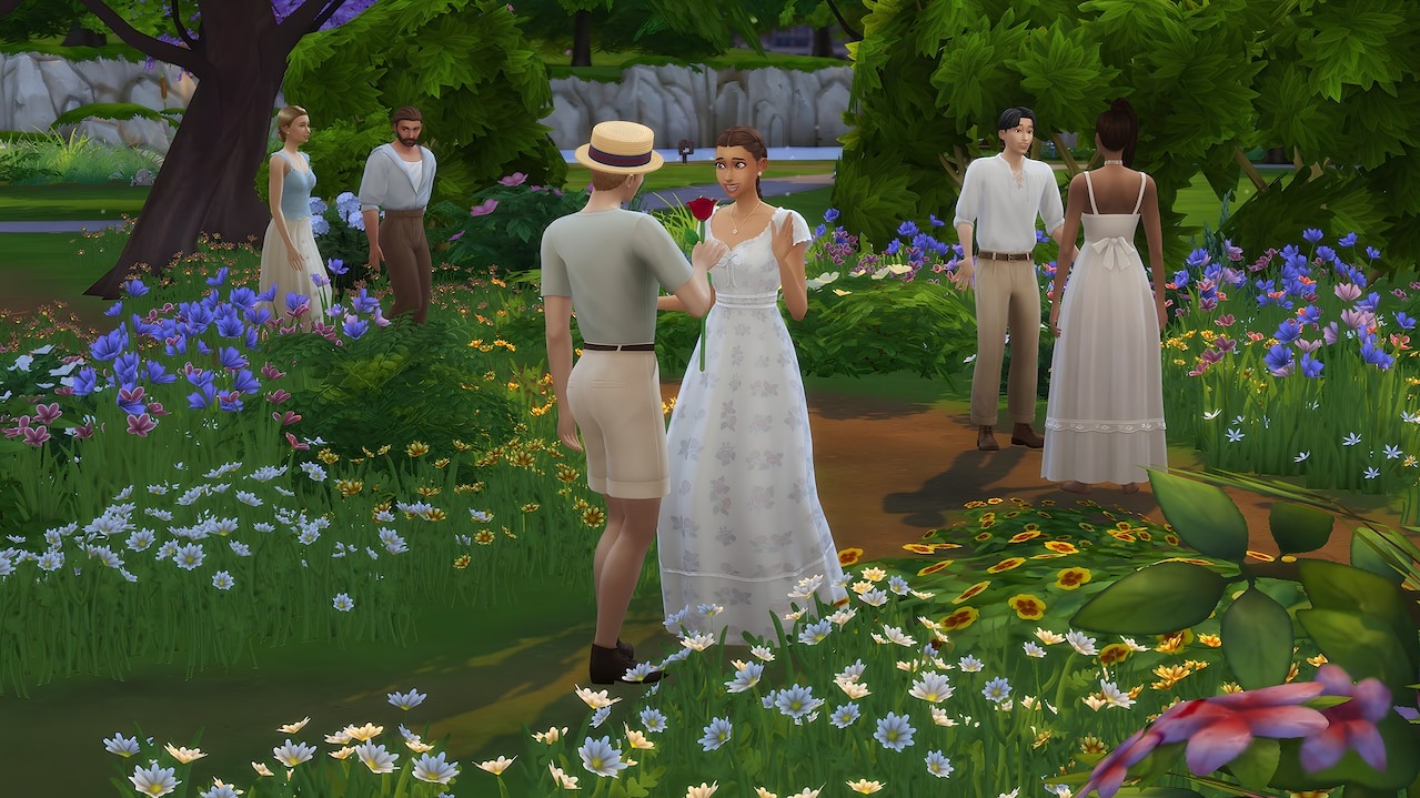Sims in prairie-style outfits stroll and chat in a meadow full of wildflowers, with one Sim offering a flower to another.